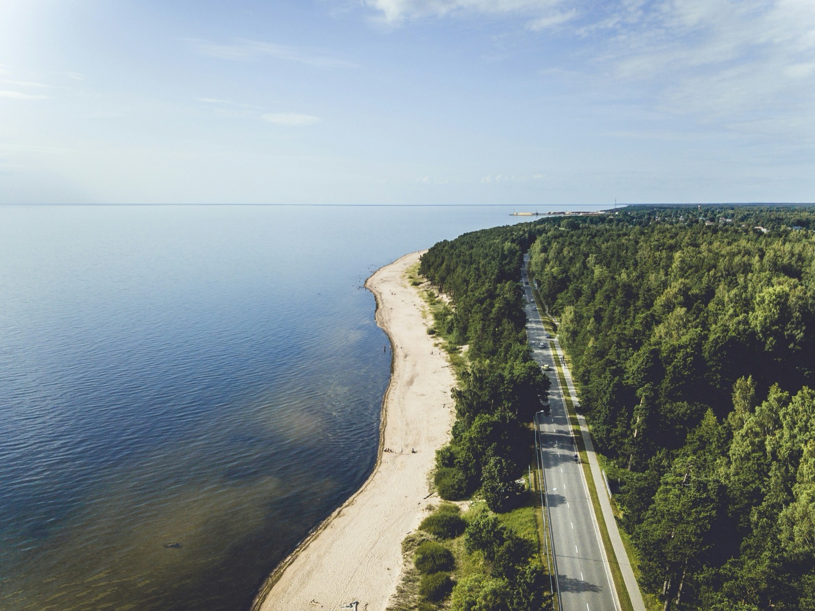 Aerial view of the coastal road, beach and pine forest near Saulkrasti, Latvia
