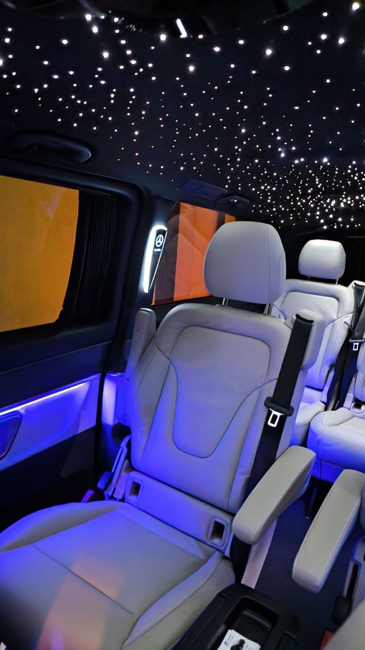 V-Class passenger cabin with blue ambient lighting and a starry ceiling