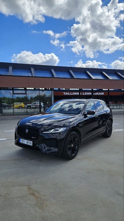 Black Jaguar F-Pace parked in front of the Tallinn Airport terminal
