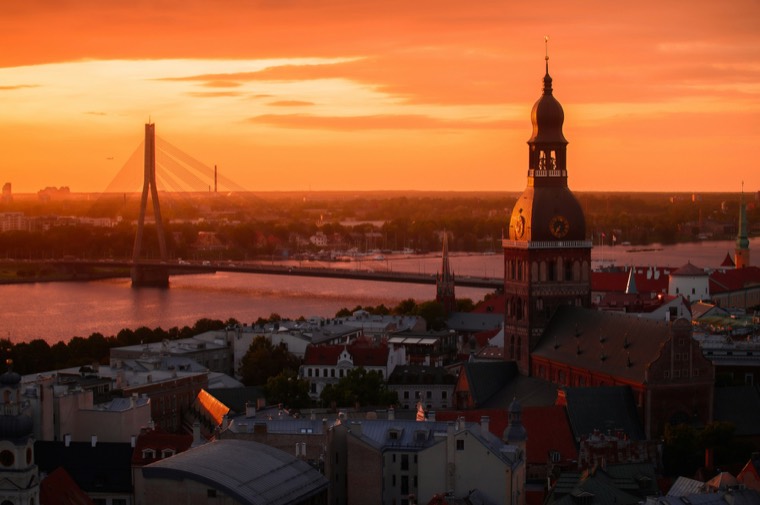 Riga at sunset with the cathedral tower and the cable-stayed bridge over the Daugava