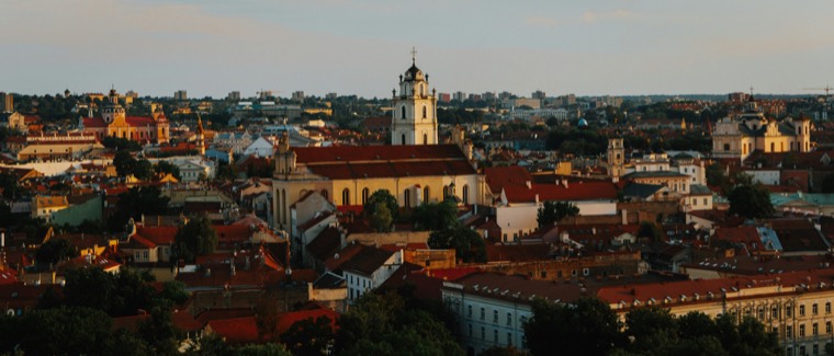 Vilnius Old Town rooftops and the bell tower of St. Johns' Church in evening light